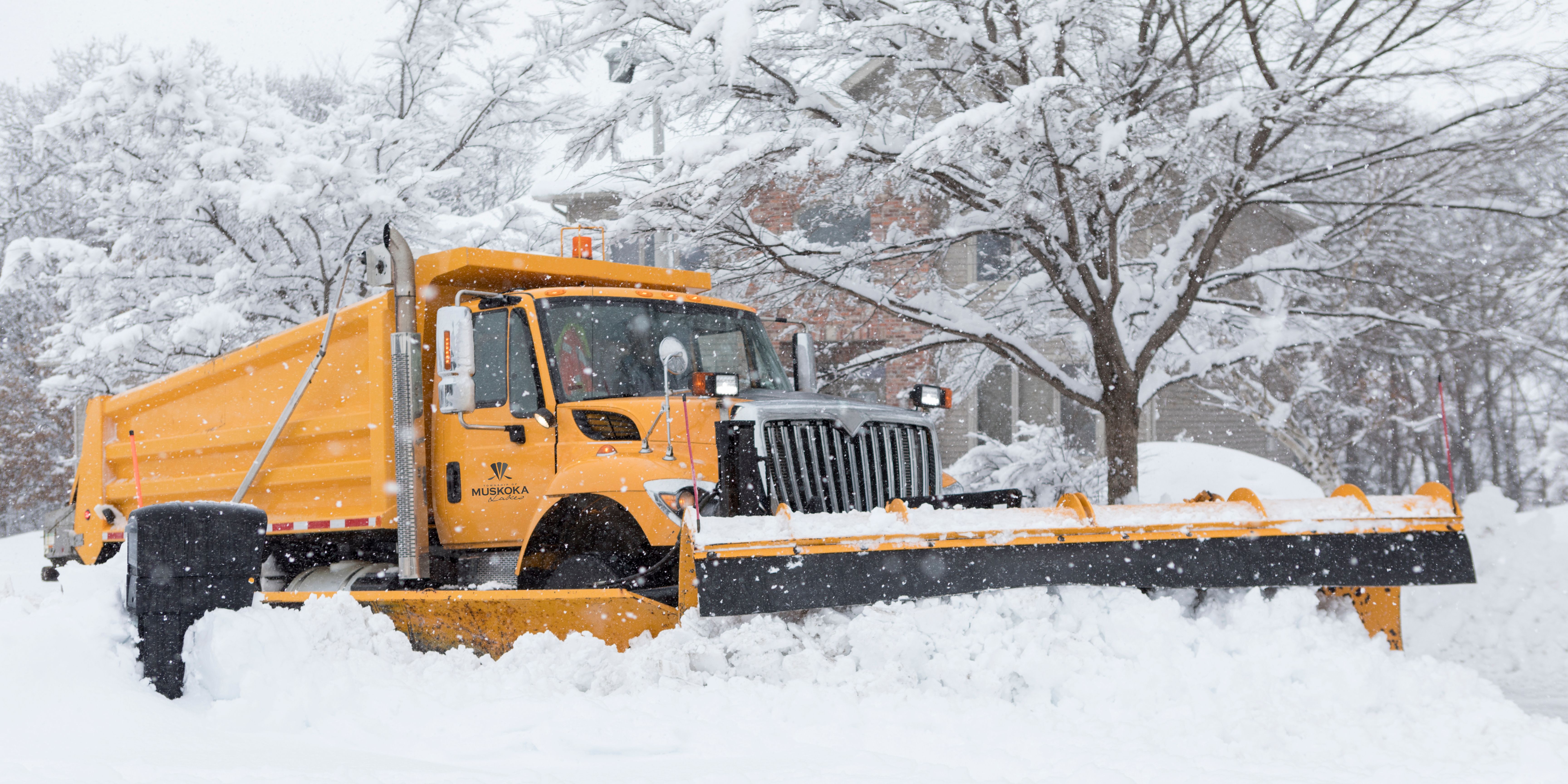 A snow plow plowing the road
