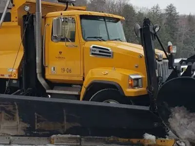 A snow plow plowing the road