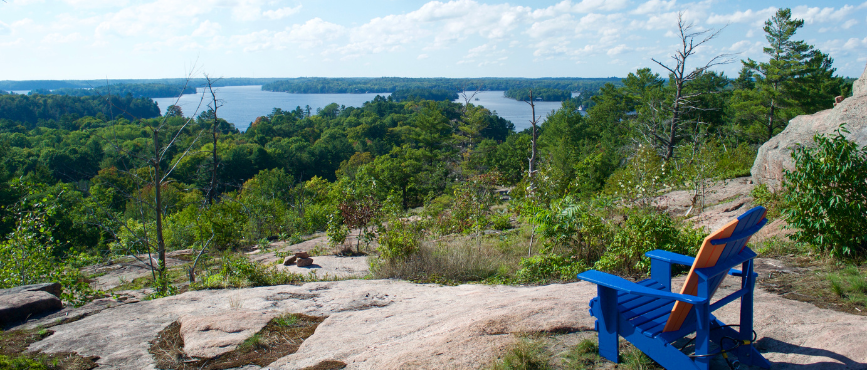 Muskoka chair on a rocky outcropping