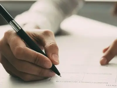 A person filling out an application