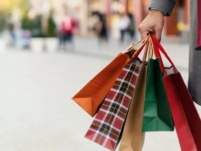 A person holding multiple shopping bags